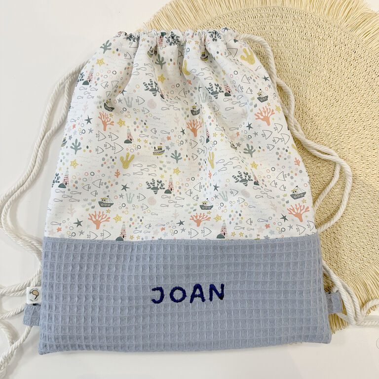Motxilla sac infantil amb cordes de tela sota la mar i gofre blau